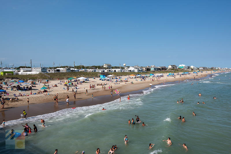 Swimmers and sun bathers next to Bogue Inlet Fishing Pier